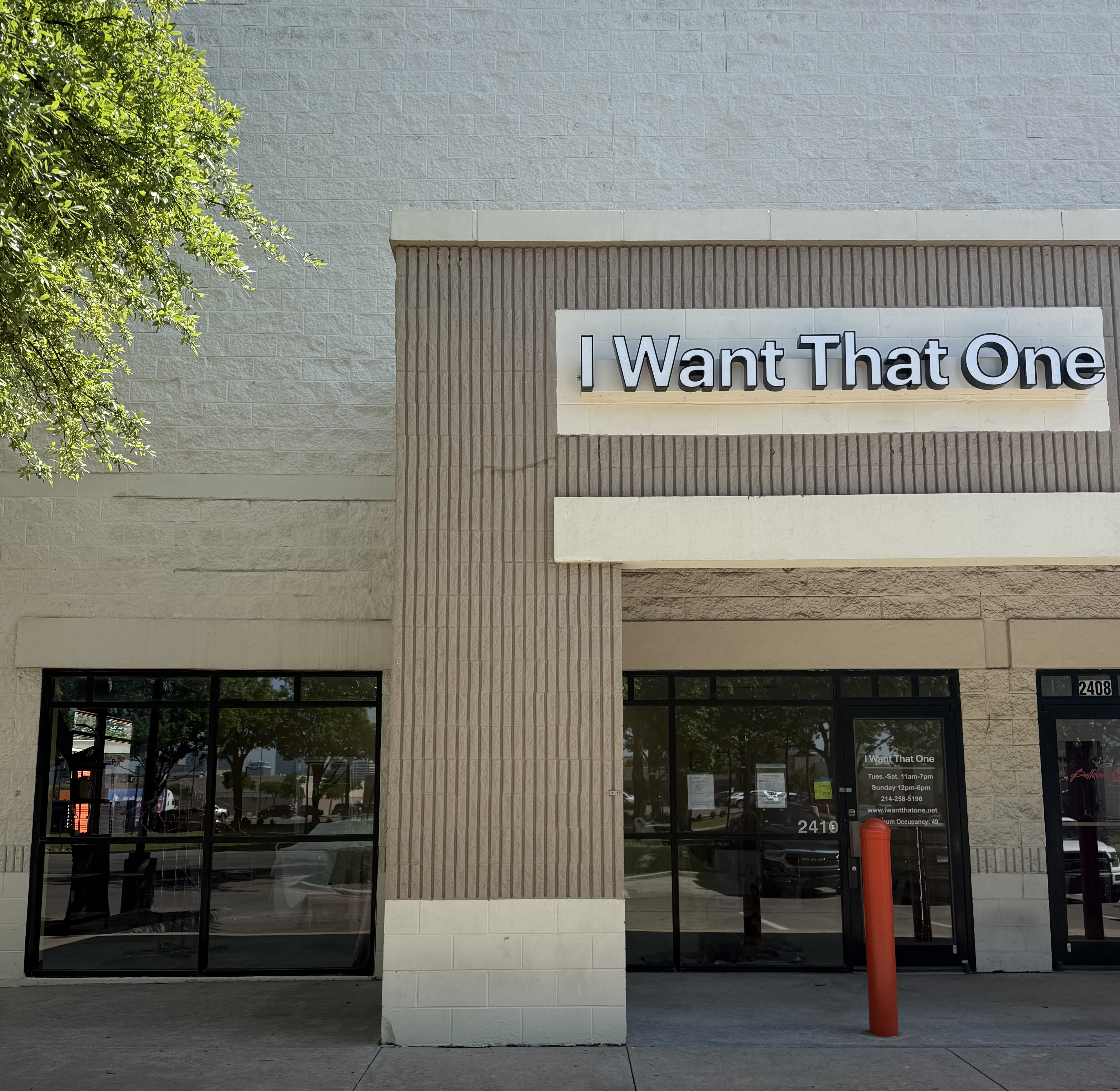 The I Want That One storefront sign goes up